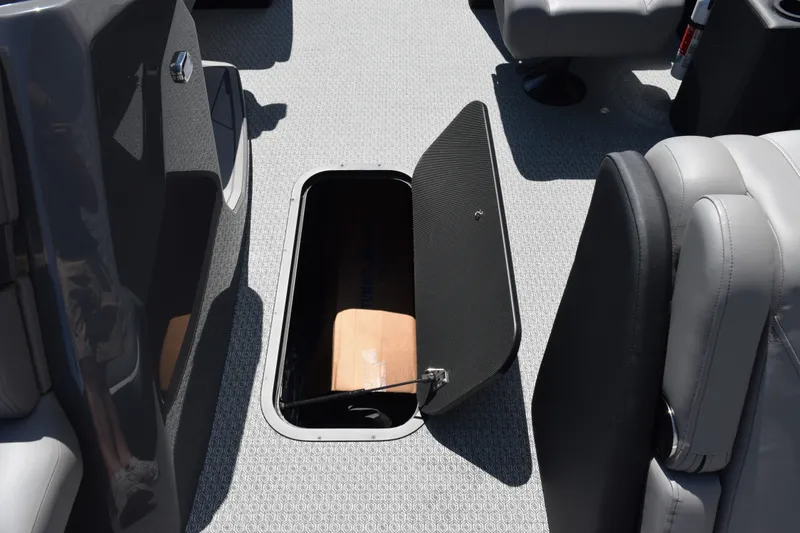Slide: The Image of Open storage compartment on 2026 Evotti 523QL boat with gray seating and flooring. - 16