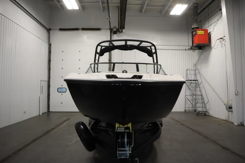 Slide: The Image of 2026 Yamaha Boats AR250 in a garage, front view, under bright lighting. - 1