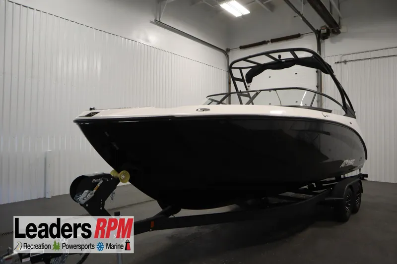 The Image of 2026 Yamaha Boats AR250 in showroom, black and white design, on trailer. - 0