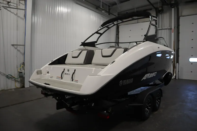 Slide: The Image of 2026 Yamaha AR250 boat in a garage, showcasing sleek design and modern features. - 4