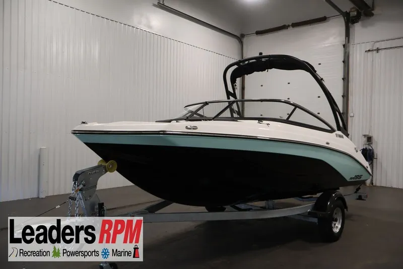 The Image of 2026 Yamaha Boats AR195 in showroom, displayed on trailer, Leaders RPM branding visible. - 0