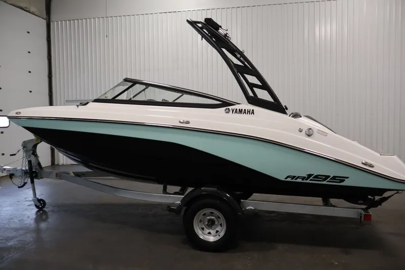 Slide: The Image of 2026 Yamaha Boats AR195 on trailer in indoor setting, showcasing sleek design. - 13