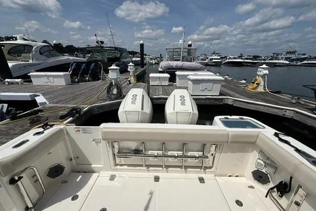 Slide: The Image of 2020 Boston Whaler 325 Conquest docked at marina with twin engines. - 7