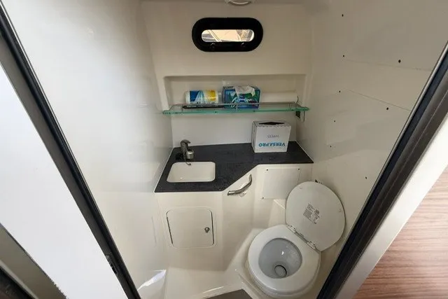 Slide: The Image of Bathroom interior of 2020 Boston Whaler 325 Conquest boat with sink and toilet. - 23