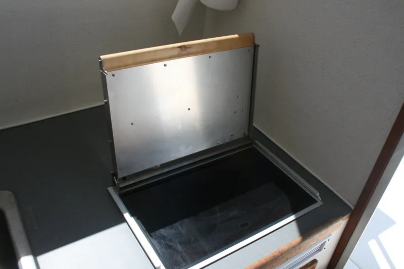 Slide: The Image of 2007 Sea Sport 2200 Sportsman interior storage compartment with metal lid. - 7
