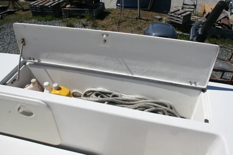 Slide: The Image of Storage compartment on a 2007 Sea Sport 2200 Sportsman boat with rope and bottles. - 11