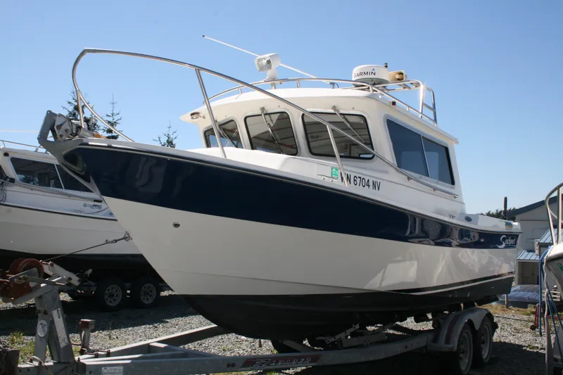Slide: The Image of 2007 Sea Sport 2200 Sportsman boat on trailer, featuring a sleek design and Garmin equipment. - 1