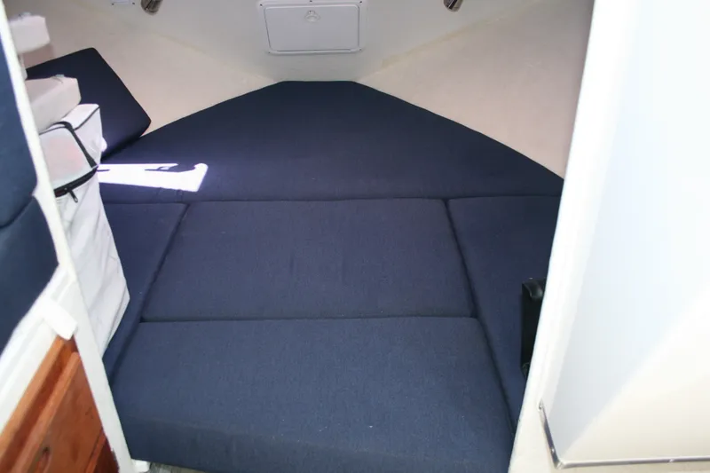 Slide: The Image of 2007 Sea Sport 2200 Sportsman cabin interior with blue cushions and storage compartments. - 8