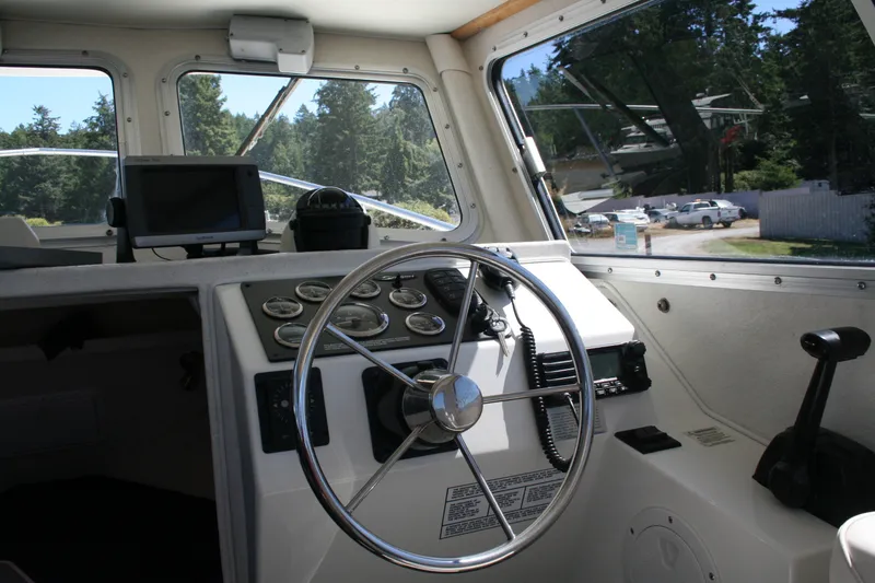 Slide: The Image of Interior of 2007 Sea Sport 2200 Sportsman boat with steering wheel and navigation equipment. - 2
