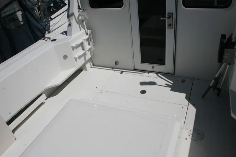 Slide: The Image of 2007 Sea Sport 2200 Sportsman boat deck with white interior and door. - 10