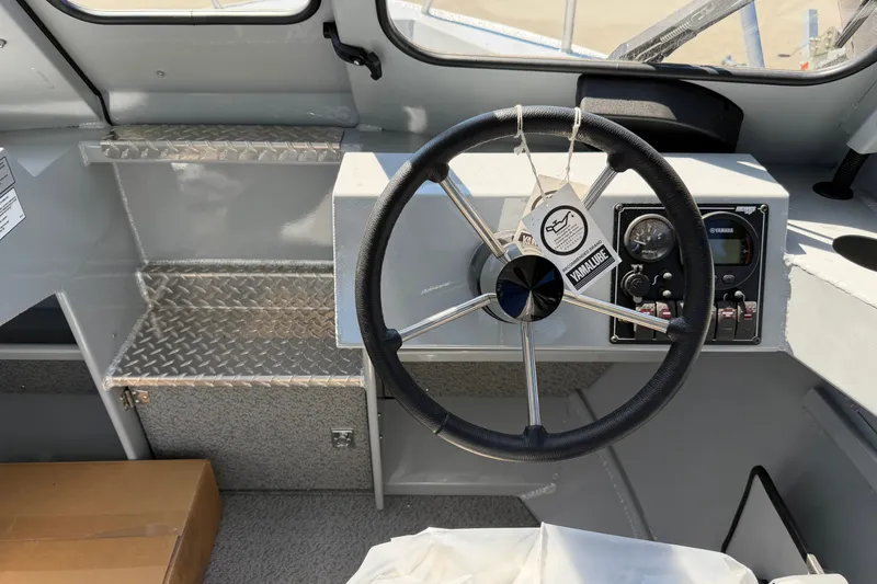 Slide: The Image of The image shows the helm of a Hewescraft 180 ProV Hard Top boat with a modern dashboard. - 7