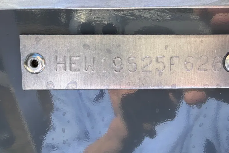 Slide: The Image of Close-up of a metal plate with an engraved serial number on a boat. - 11