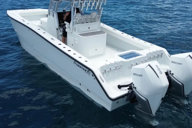 Slide: The Image of 2022 Freeman 34VH boat with dual Mercury engines on open water. - 3