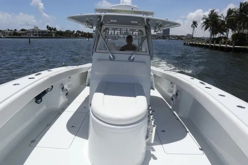 Slide: The Image of 2022 Freeman 34VH boat cruising on a sunny day, with palm trees in the background. - 37