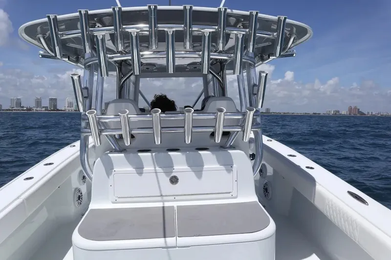 Slide: The Image of 2022 Freeman 34VH boat cruising on open water with city skyline in background. - 25