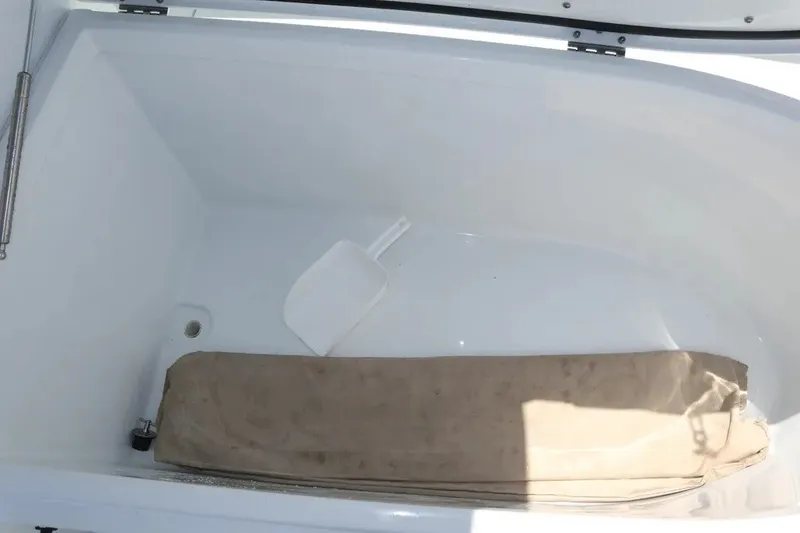 Slide: The Image of Open storage compartment in 2022 Freeman 34VH boat with beige cushion and white scoop. - 41