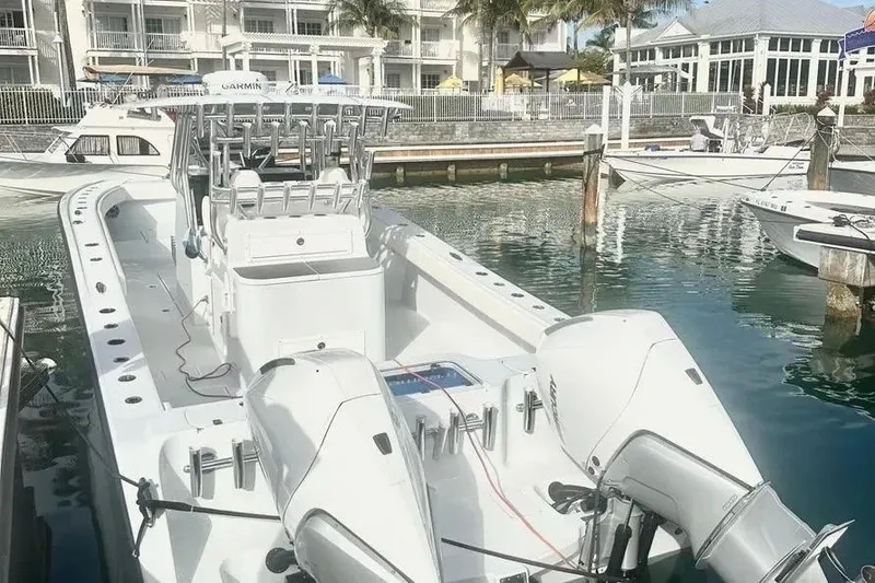 Slide: The Image of 2022 Freeman 34VH boat docked at marina with twin engines and modern design. - 14