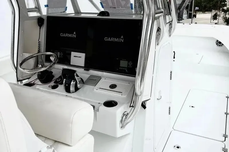 Slide: The Image of 2022 Freeman 34VH boat cockpit with Garmin navigation displays and Mercury controls. - 12