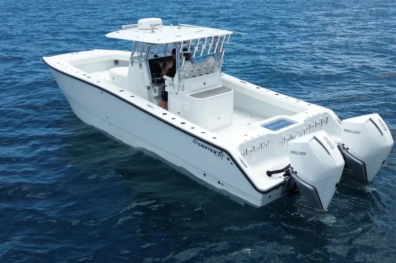 Slide: The Image of 2022 Freeman 34VH boat with twin Mercury engines on open water. - 2