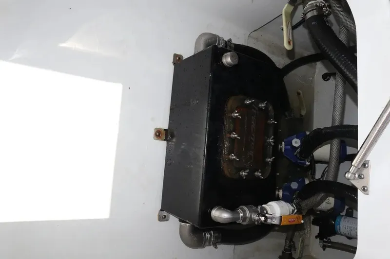Slide: The Image of Engine compartment of a 2022 Freeman 34VH boat, featuring hoses and mechanical components. - 33