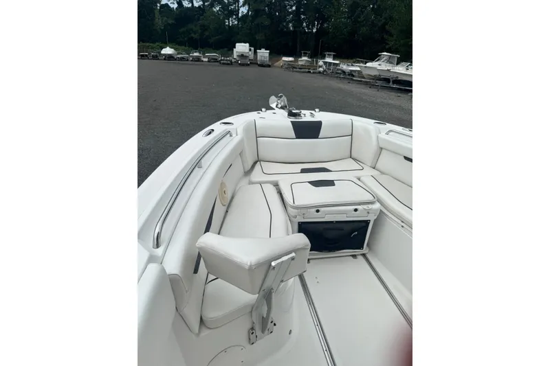 Slide: The Image of 2021 Wellcraft 262 Fisherman boat interior with white seating and storage compartments. - 16