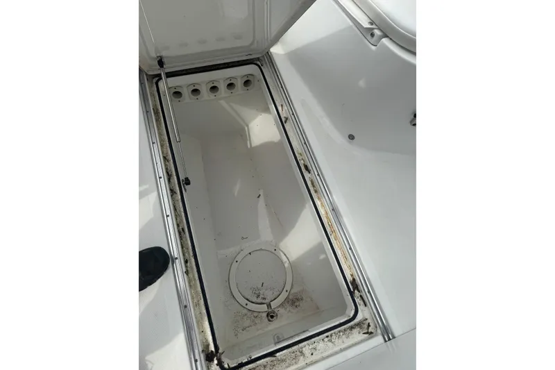 Slide: The Image of Open storage compartment on 2021 Wellcraft 262 Fisherman boat, showing interior details. - 19