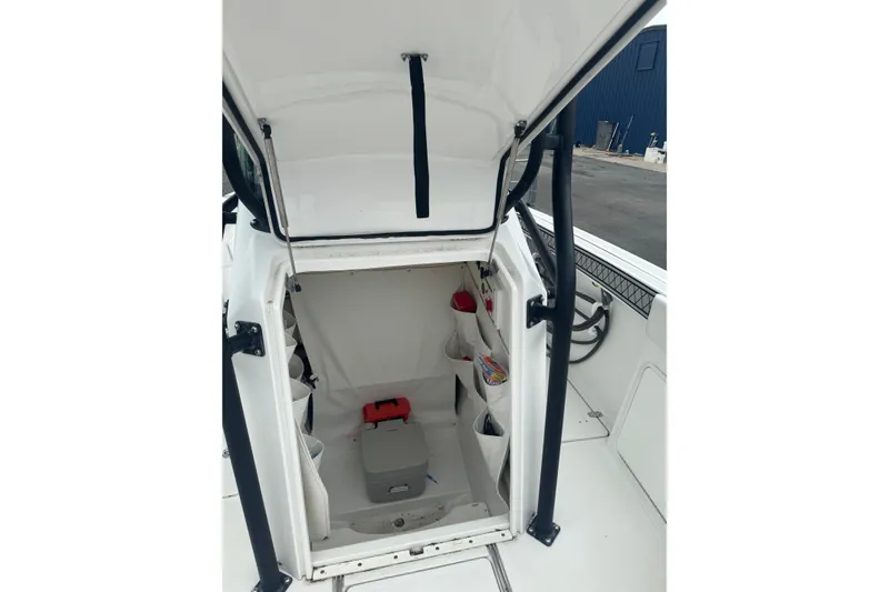 Slide: The Image of 2021 Wellcraft 262 Fisherman boat interior storage compartment with open hatch. - 14