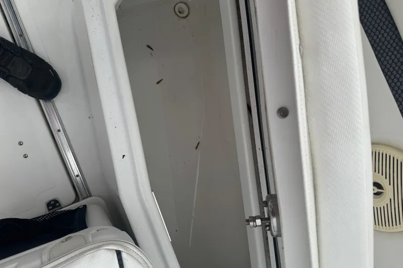 Slide: The Image of Interior view of a 2021 Wellcraft 262 Fisherman boat, showcasing storage compartment. - 18