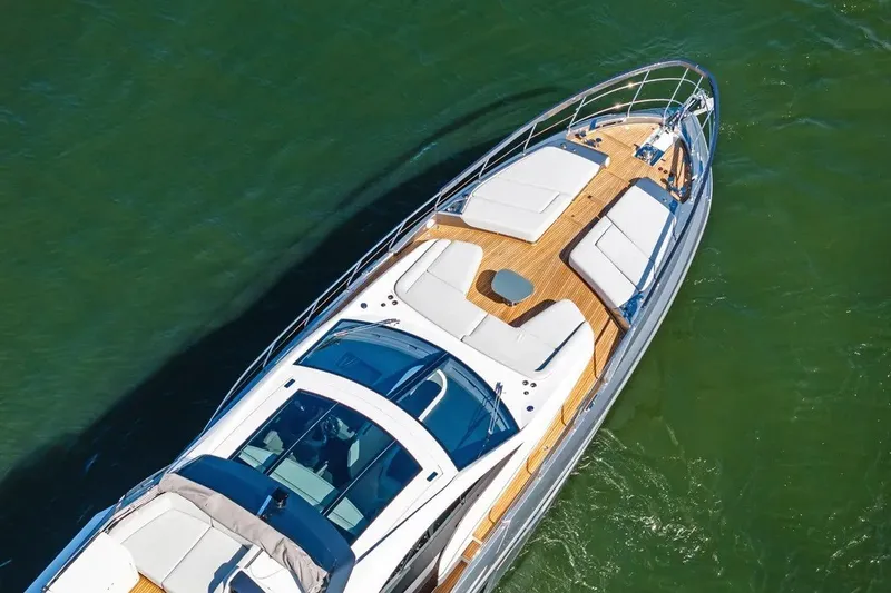 Slide: The Image of 2024 Azimut S8 yacht with sleek design and luxurious deck on green water. - 13