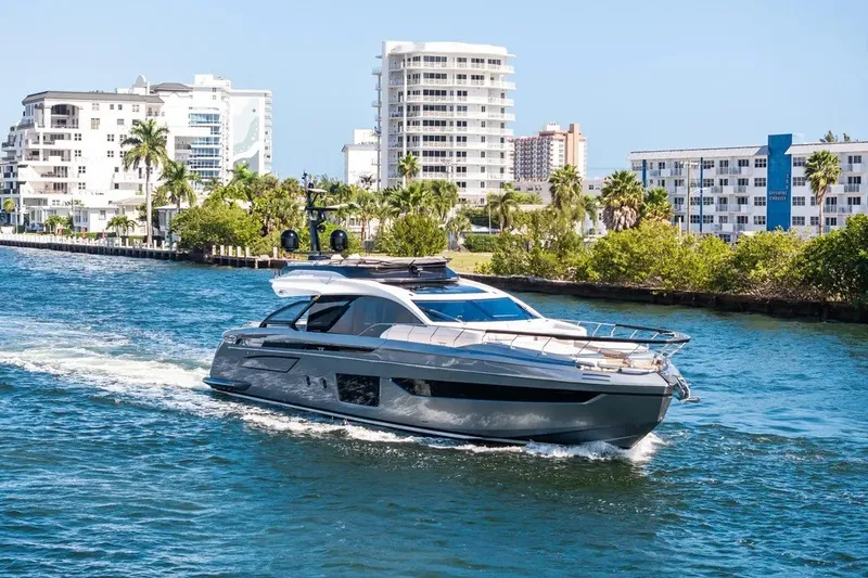 The Image of 2024 Azimut S8 yacht cruising in a scenic coastal city waterway. - 2