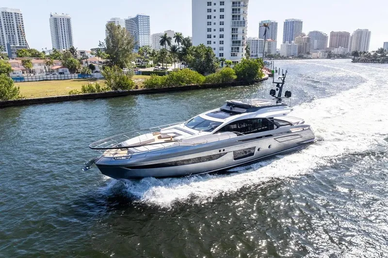 Slide: The Image of The 2024 Azimut S8 cruising on a waterway with city buildings in the background. - 40
