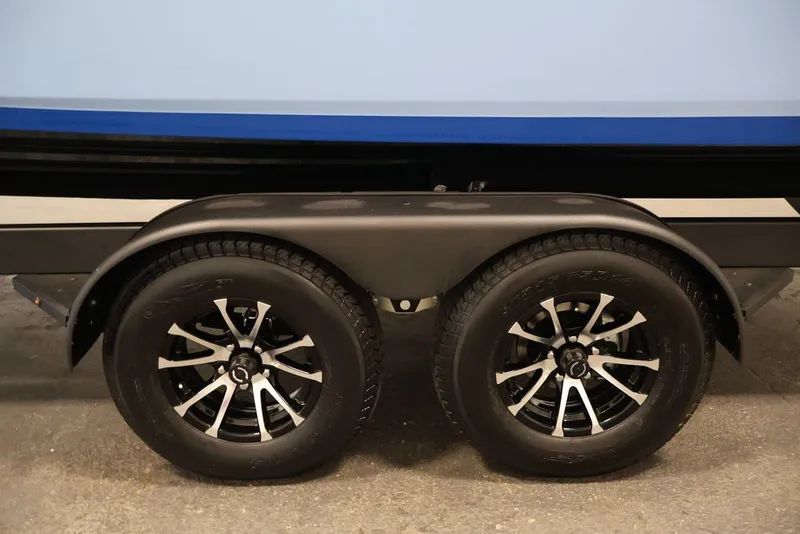 Slide: The Image of Trailer wheels of a 2026 Yamaha Boats 252SD, featuring sleek black and silver rims. - 37