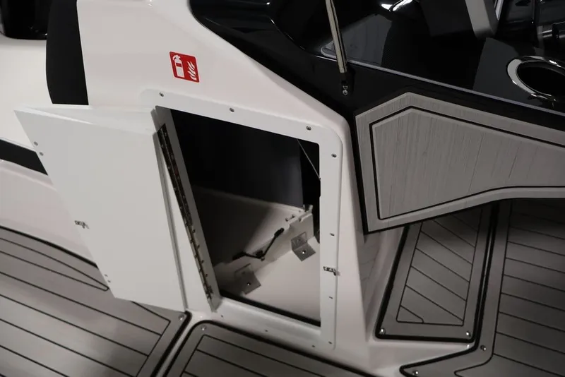 Slide: The Image of Open storage compartment on 2026 Yamaha Boats 252SD, featuring sleek interior design and flooring. - 35