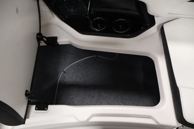 Slide: The Image of Interior view of 2026 Yamaha Boats 252SD, featuring carpeted flooring and cup holders. - 47