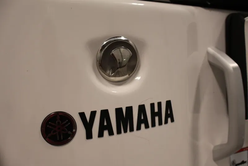 Slide: The Image of Close-up of 2026 Yamaha Boats 252SD logo and handle on white surface. - 32