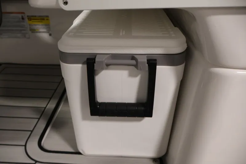 Slide: The Image of White cooler with black handle on 2026 Yamaha Boats 252SD deck. - 30