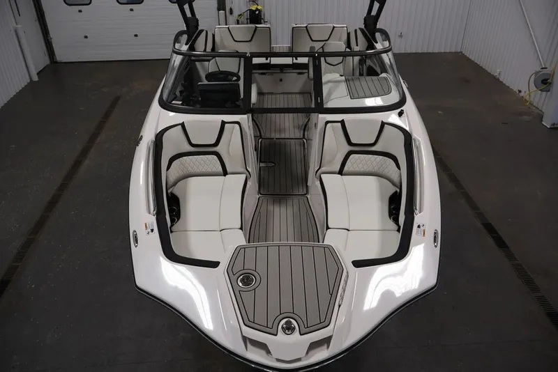 Slide: The Image of 2026 Yamaha Boats 252SD interior, featuring sleek seating and modern design in a showroom setting. - 19