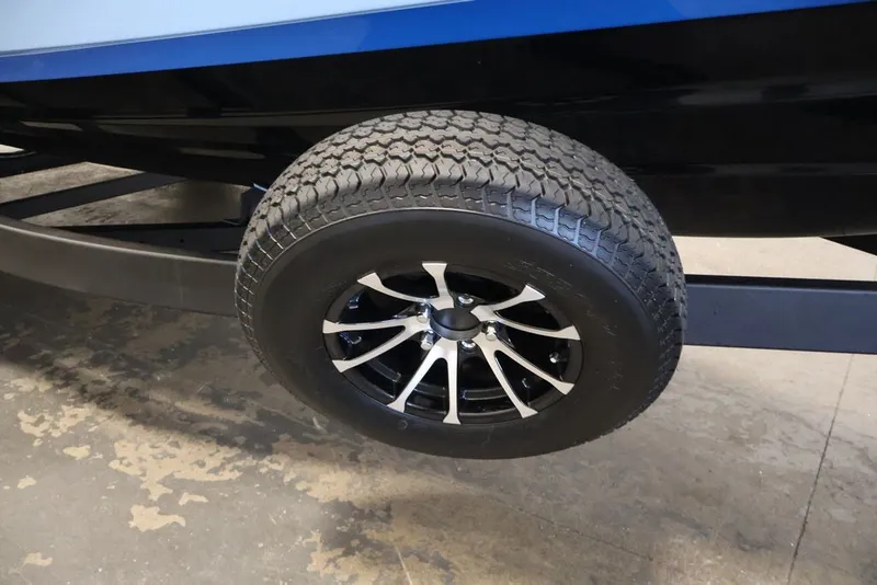 Slide: The Image of Trailer wheel of 2026 Yamaha Boats 252SD, featuring sleek black and silver design. - 40