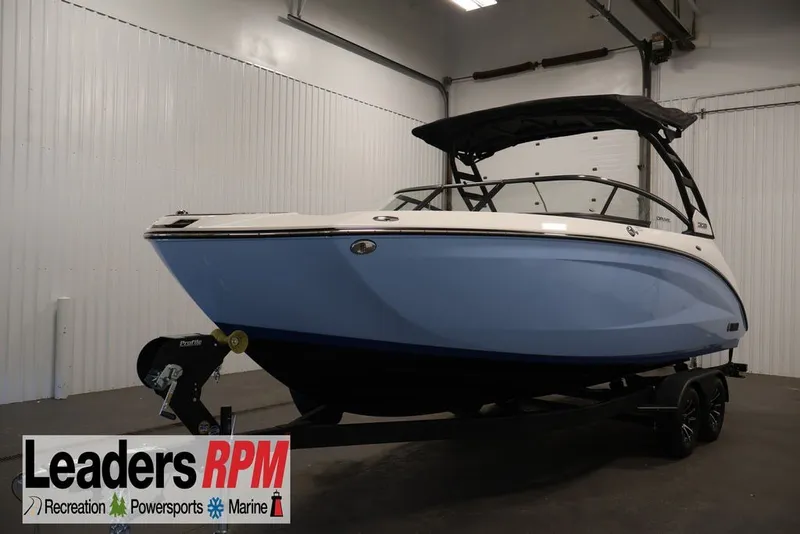 Slide: The Image of 2026 Yamaha Boats 252SD in showroom, blue hull, black canopy, Leaders RPM branding. - 43