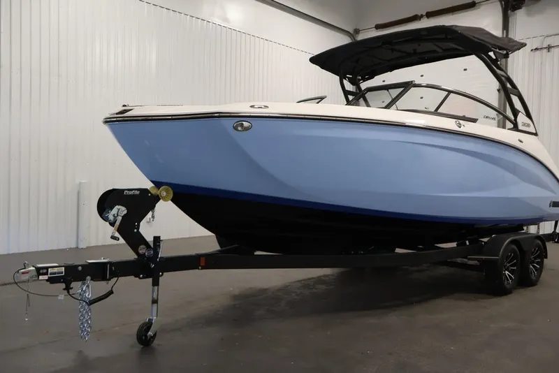 Slide: The Image of 2026 Yamaha Boats 252SD in showroom, featuring sleek design and modern trailer. - 41
