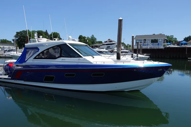 The Image of 2022 Formula 380 Super Sport Crossover OB docked in a marina under clear skies. - 0