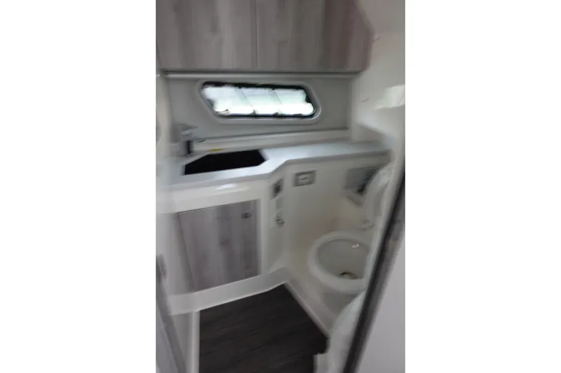 Slide: The Image of Interior of 2022 Formula 380 Super Sport Crossover OB boat bathroom with sink and toilet. - 25