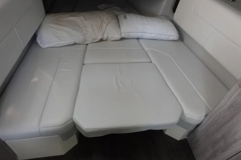 Slide: The Image of 2022 Formula 380 Super Sport Crossover OB cabin with white cushioned bed and pillows. - 23