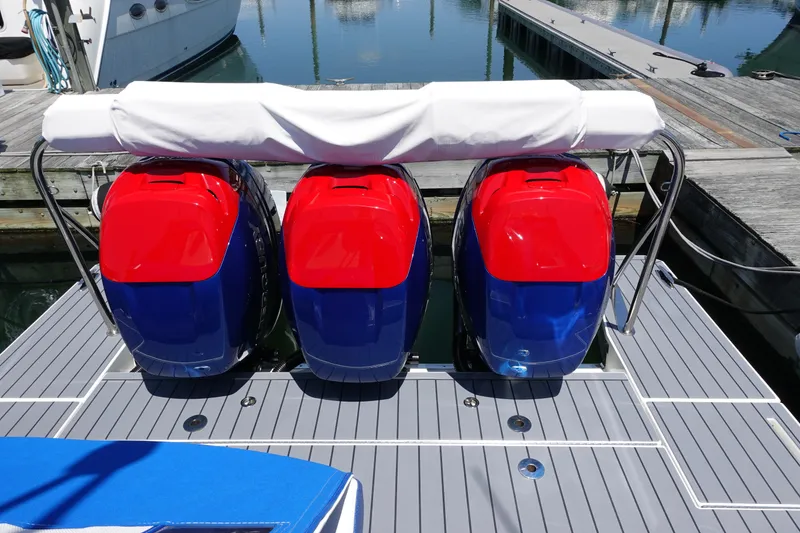 Slide: The Image of 2022 Formula 380 Super Sport Crossover OB with three vibrant outboard motors at dock. - 6