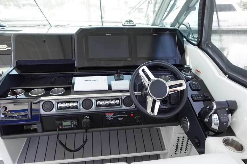 Slide: The Image of 2022 Formula 380 Super Sport Crossover OB helm with modern controls and dual displays. - 7