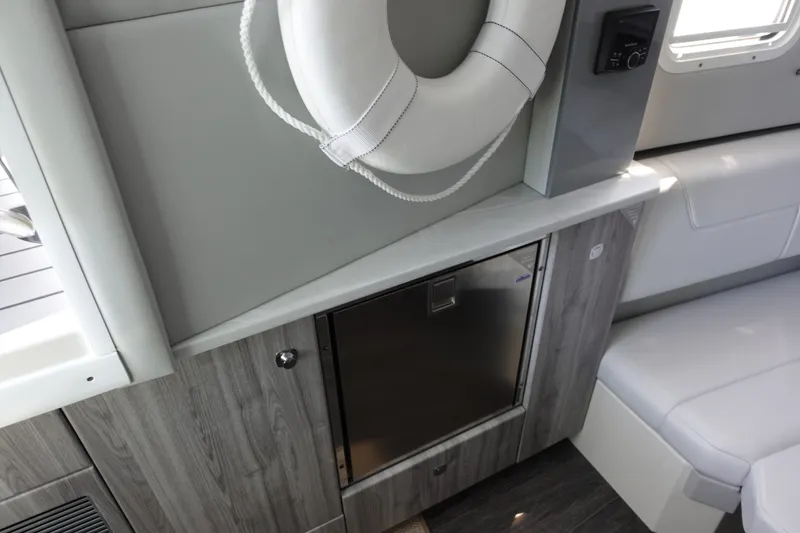 Slide: The Image of Interior of 2022 Formula 380 Super Sport Crossover OB with life preserver and compact fridge. - 24
