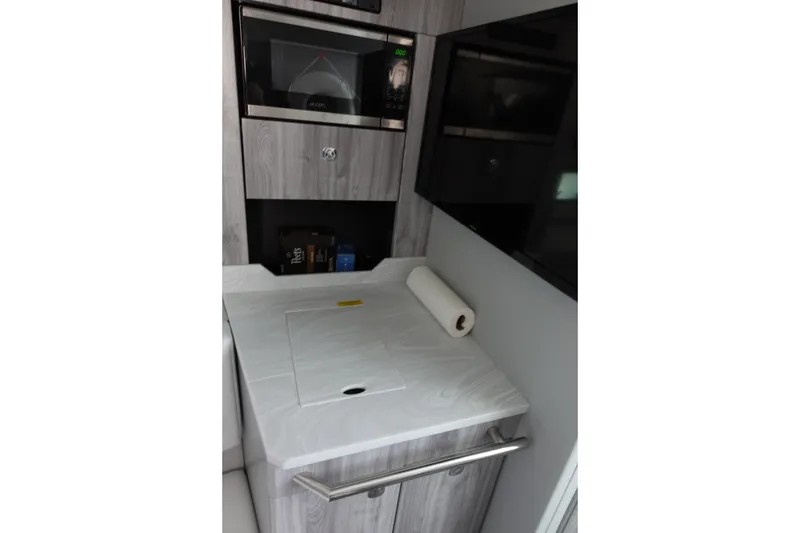 Slide: The Image of 2022 Formula 380 Super Sport Crossover OB interior with microwave and countertop. - 26