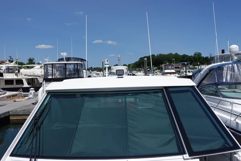 Slide: The Image of 2022 Formula 380 Super Sport Crossover OB docked at a marina under clear blue skies. - 4