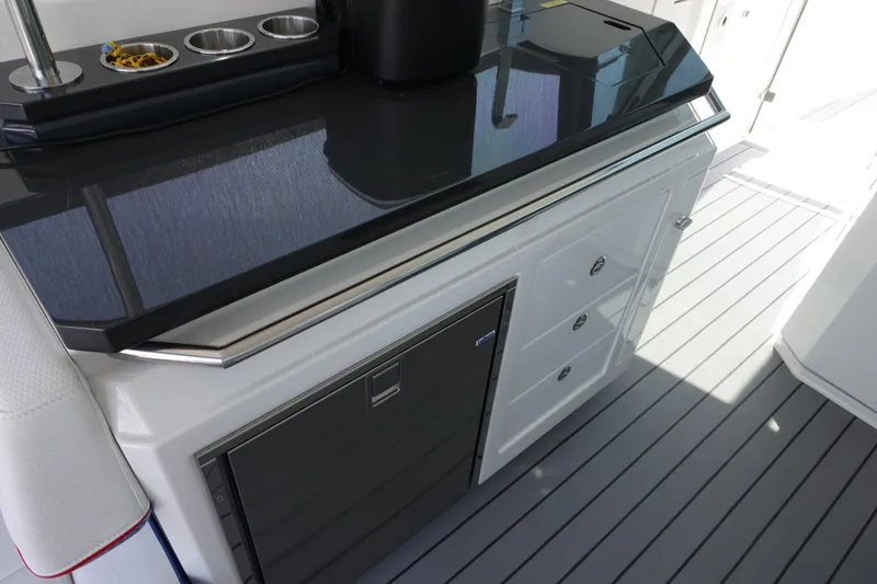 Slide: The Image of 2022 Formula 380 Super Sport Crossover OB boat interior with sleek countertop and storage. - 13