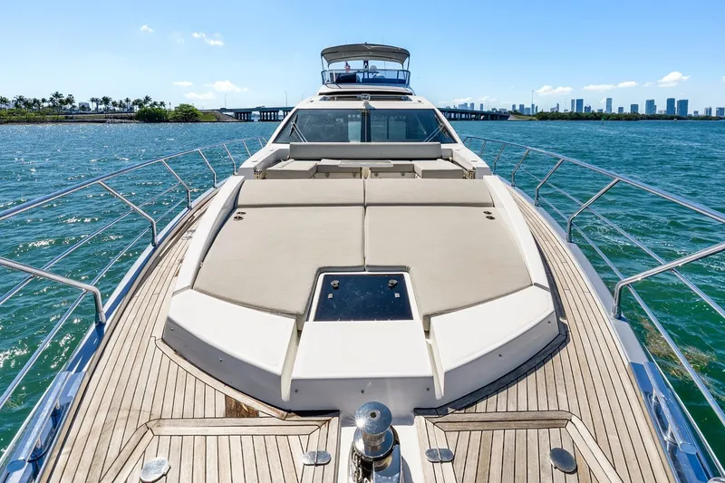 Slide: The Image of Luxurious 2018 Azimut S7 yacht cruising on clear blue waters with city skyline backdrop. - 45